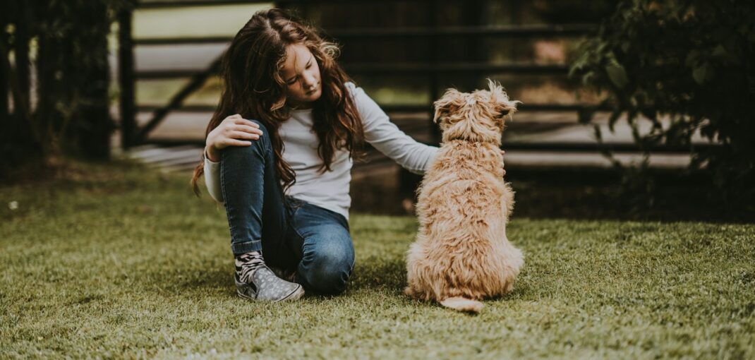 girl petting dog